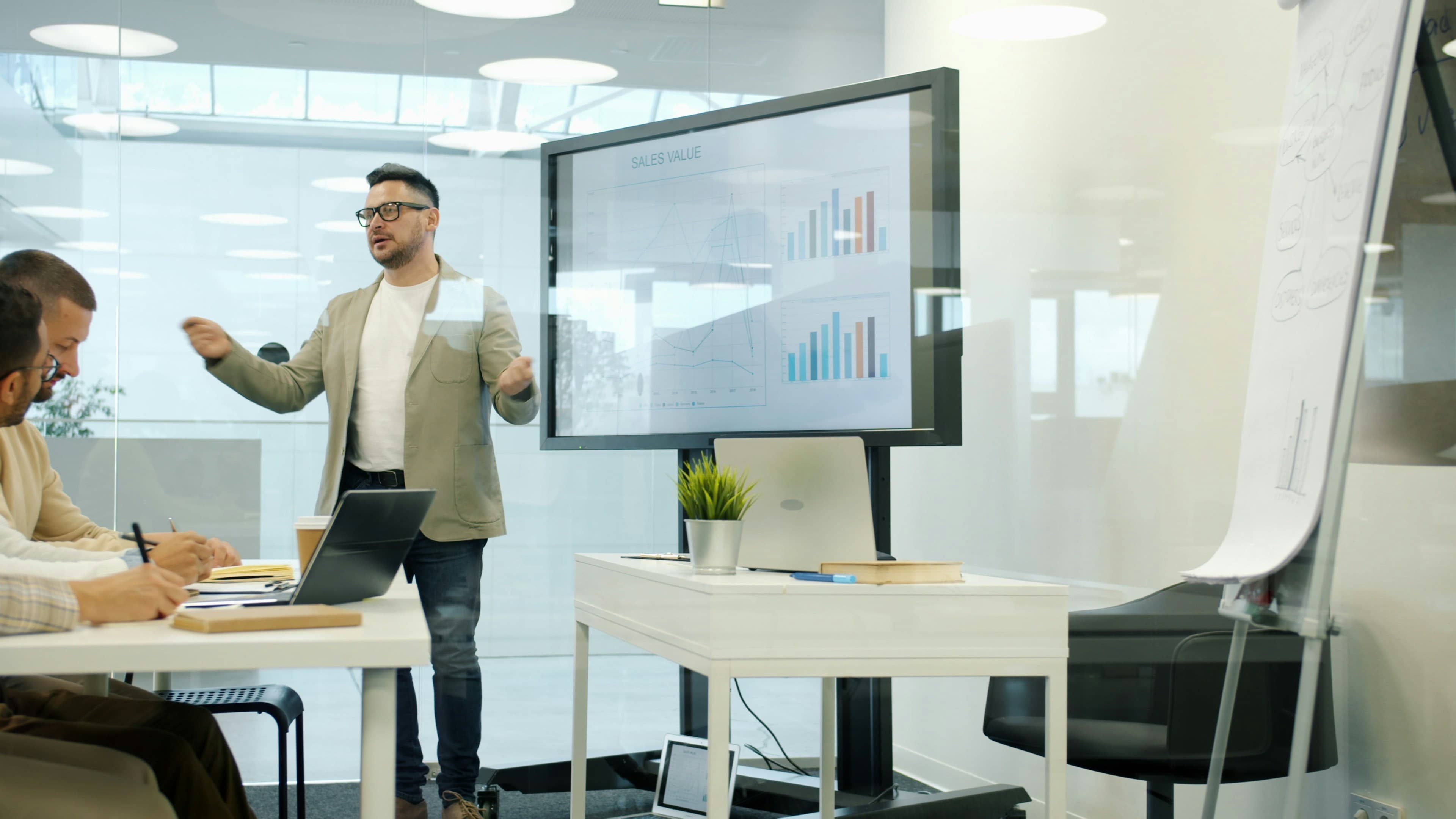 Team presenting company sales data on a screen
